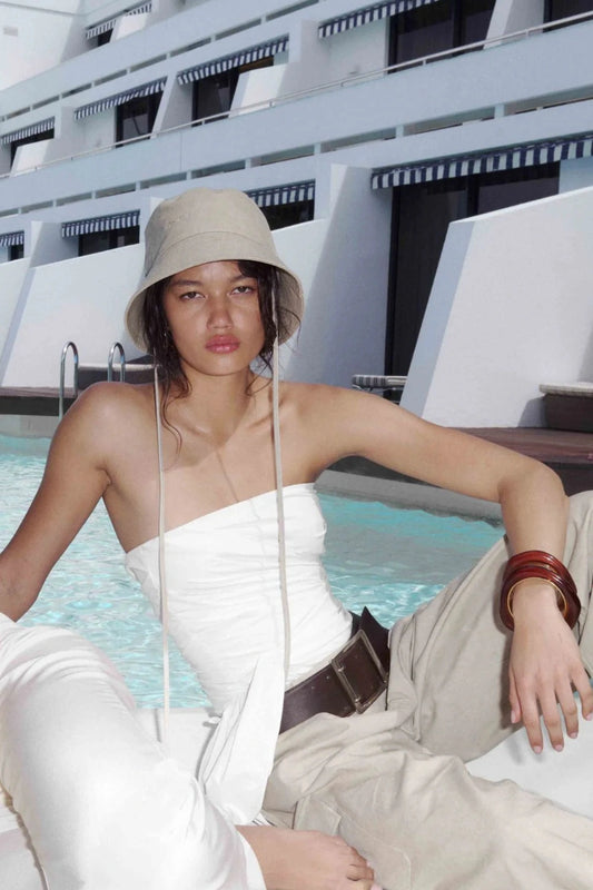 Belle Strapless Top by Bec + Bridge, a sleek nylon silhouette with tucked bodice and front tie detail—perfect for bridal or resort occasions.