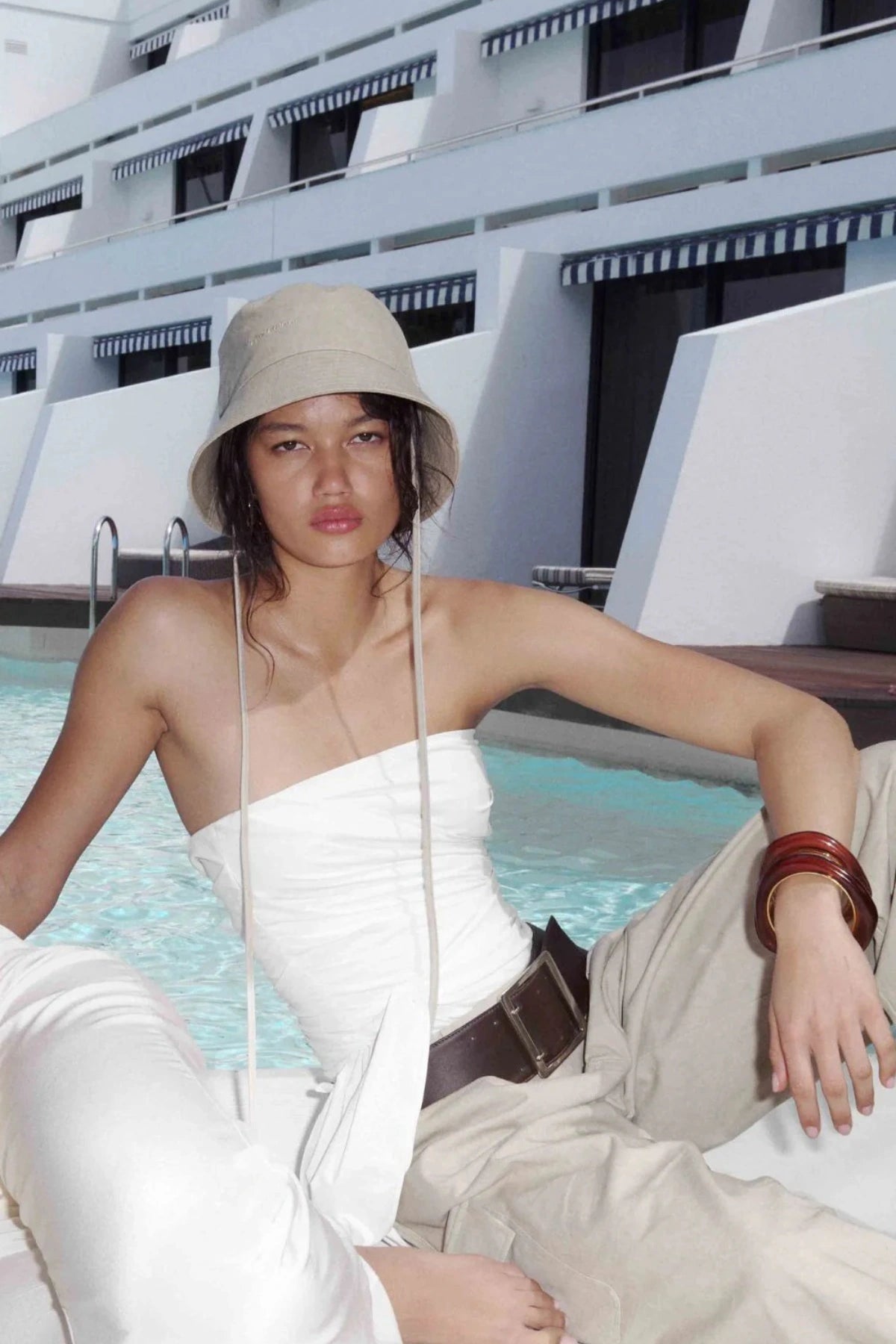 Belle Strapless Top by Bec + Bridge, a sleek nylon silhouette with tucked bodice and front tie detail—perfect for bridal or resort occasions.