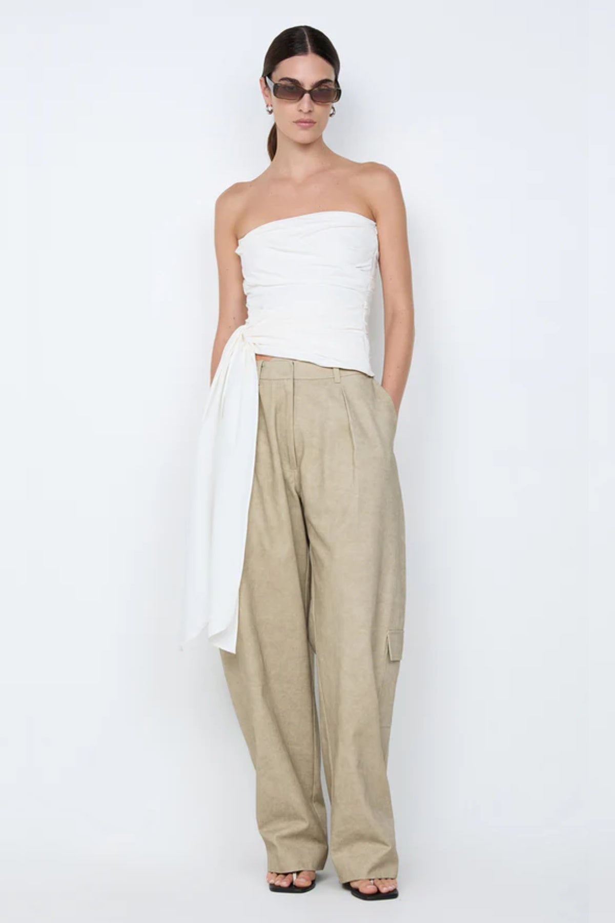 Belle Strapless Top by Bec + Bridge, a sleek nylon silhouette with tucked bodice and front tie detail—perfect for bridal or resort occasions.