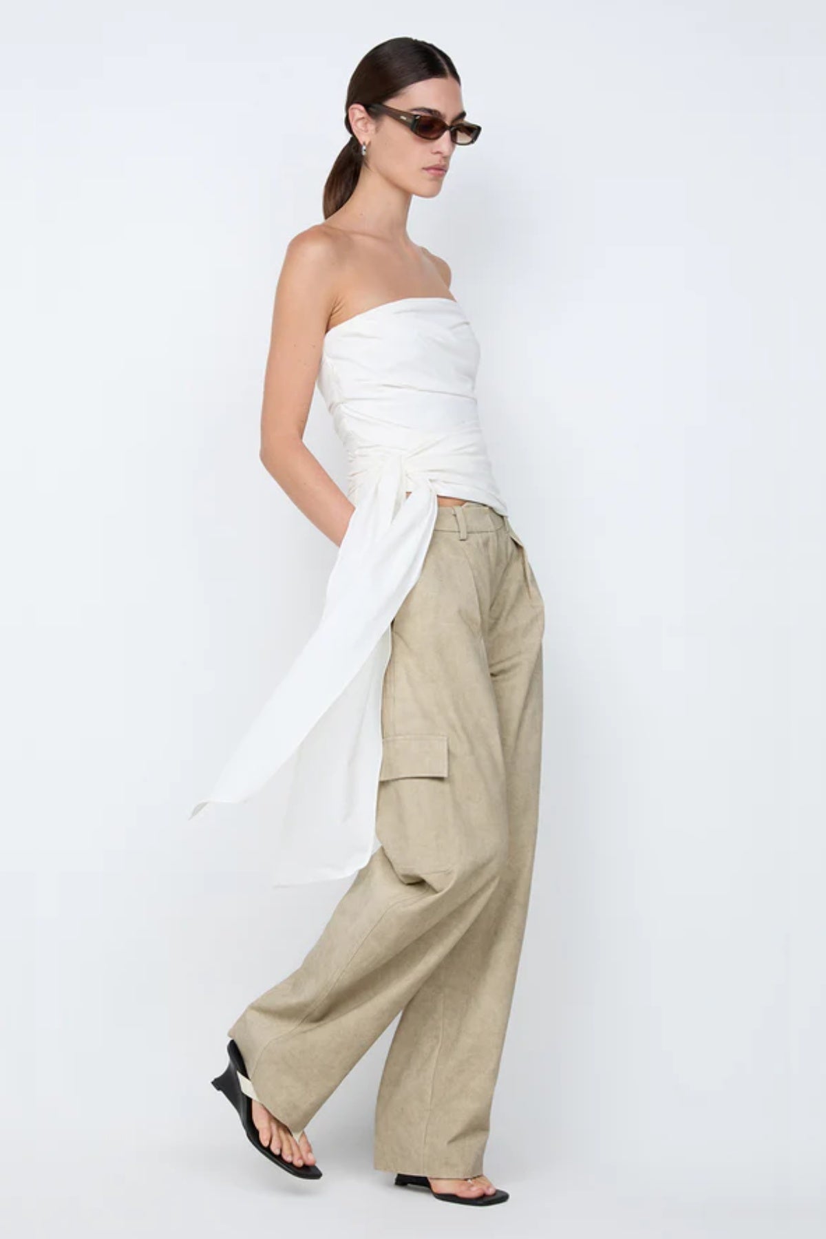 Belle Strapless Top by Bec + Bridge, a sleek nylon silhouette with tucked bodice and front tie detail—perfect for bridal or resort occasions.