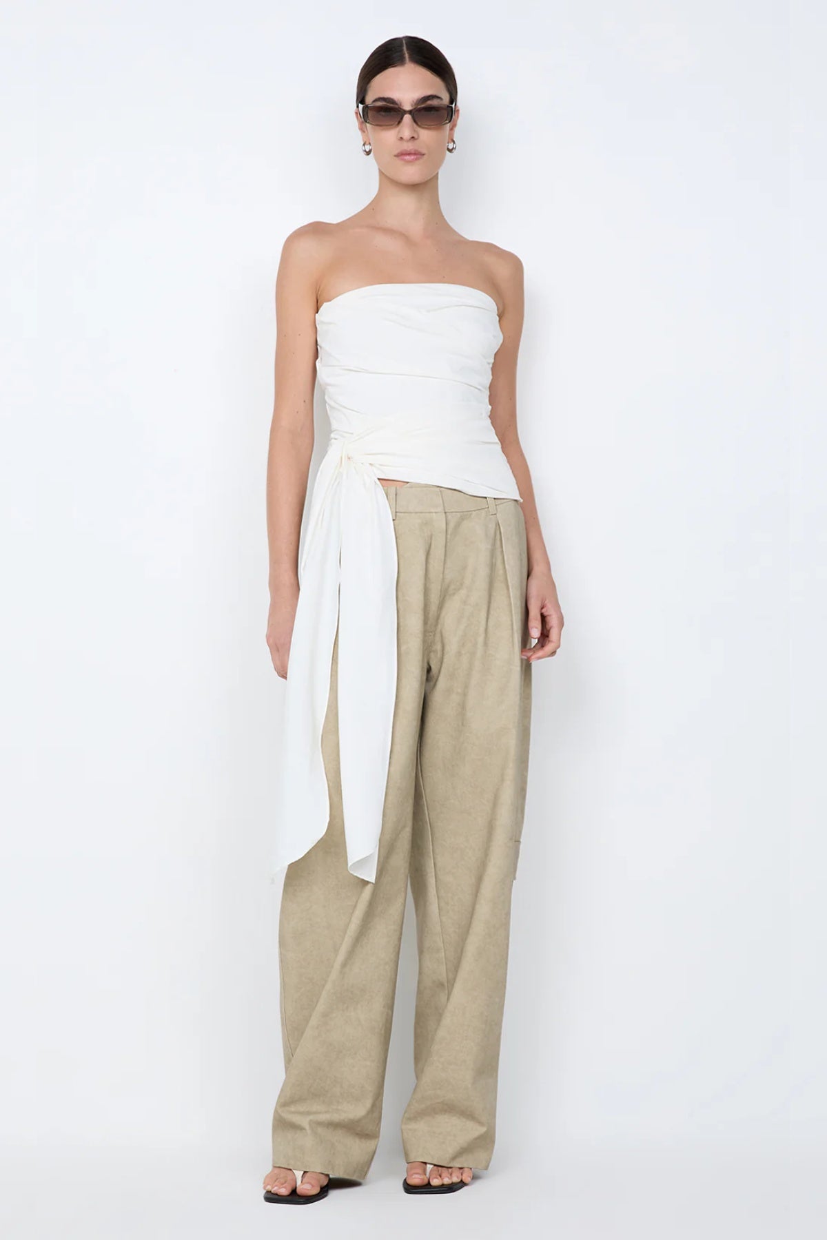 Belle Strapless Top by Bec + Bridge, a sleek nylon silhouette with tucked bodice and front tie detail—perfect for bridal or resort occasions.