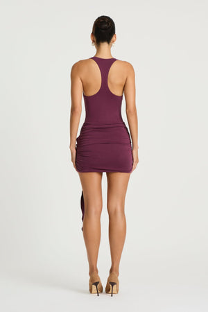 Billy Tank Mini Dress in Plum by Benni, a bodycon mini dress with scoop neckline, racerback straps, and adjustable wrap sash detail.