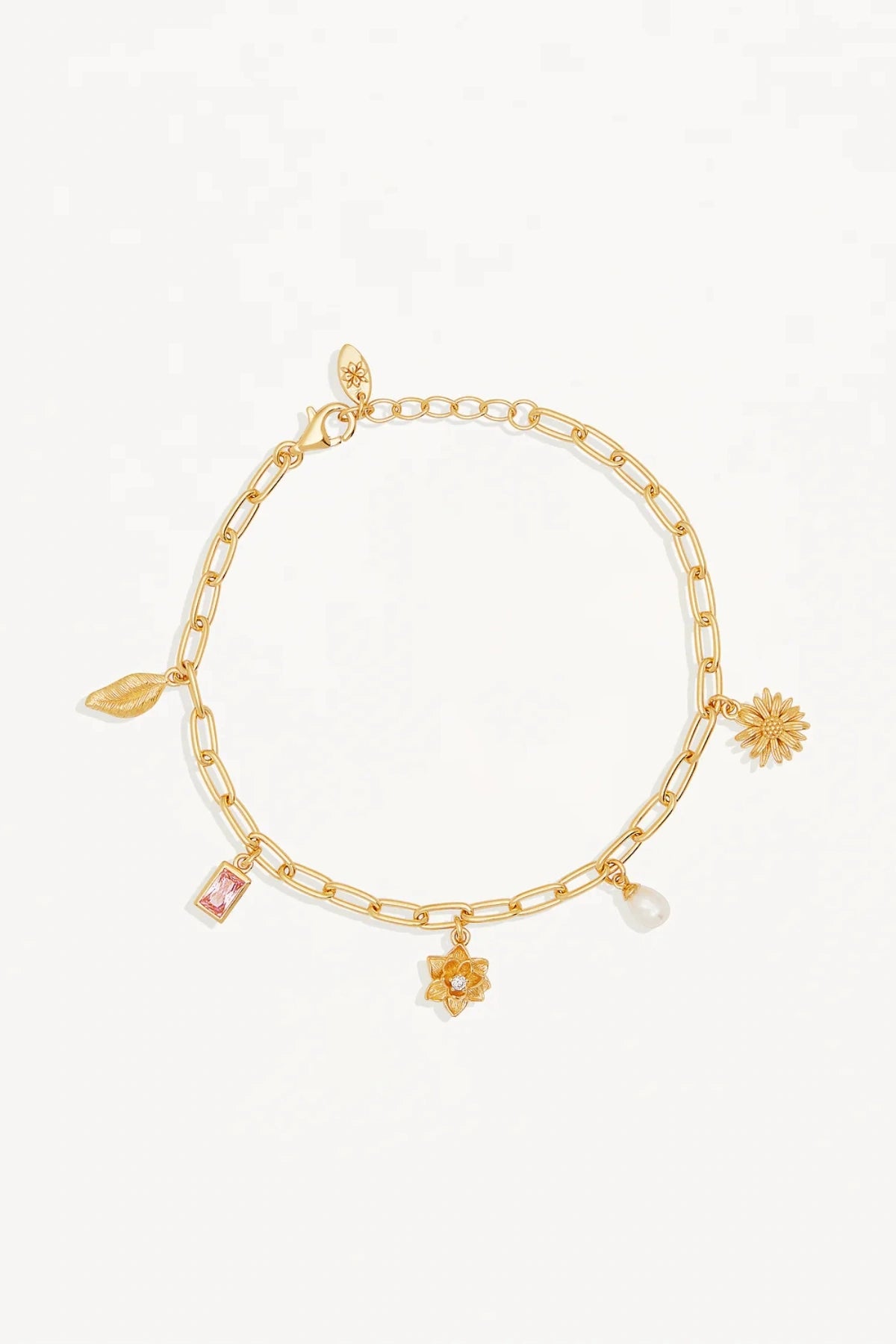 Bloom With Grace Bracelet by By Charlotte, 18k gold vermeil charm bracelet with pink crystal, lotus flower, and freshwater pearl.
