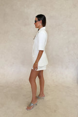 Bobbie Blazer Top White by Sneaky Link – a tailored blazer top with sharp lapels and cinched fit. Perfect for elevated styling.