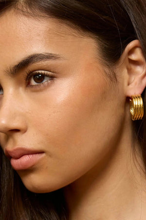 Bondi Waves Hoops Gold by Emma Pills, sculptural medium hoop earrings with ridged gold finish for elevated everyday styling.