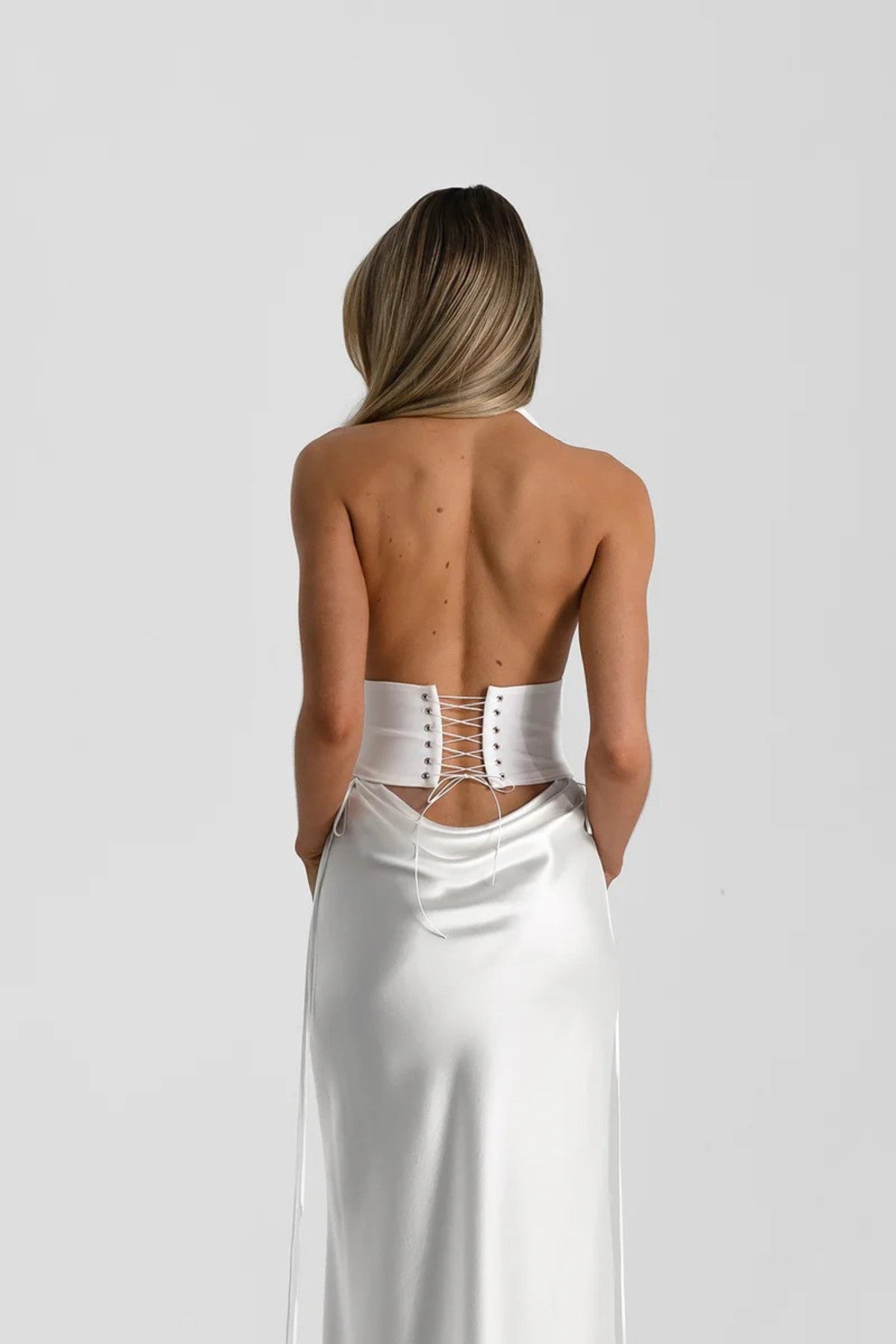 Bronte Top in White by Natalie Rolt, a ruched halter with lace-up back and curved bust. Perfect for elevated pairings or events.