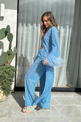 Lumière Pants Crystal by Oséree, elegant straight-leg pants in shimmering crystal blue metallic fabric. Lightweight with an elastic waistband, perfect for relaxed resort or evening wear.
