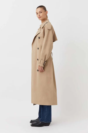 Evans Trench Coat Sand by Camilla and Marc — Oversized twill trench with double-breasted front, epaulettes, belt, and recycled polyester lining. Dry clean only.