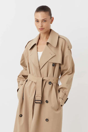Evans Trench Coat Sand by Camilla and Marc — Oversized twill trench with double-breasted front, epaulettes, belt, and recycled polyester lining. Dry clean only.