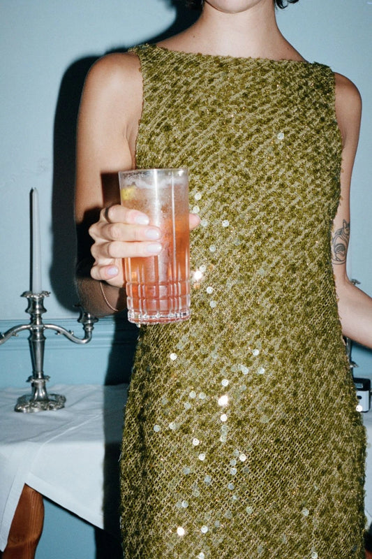 Cabine Boatneck Mini Dress in Moss by Bec + Bridge, a fully lined sequin mini with boat neckline, low scoop back, and raw hem.