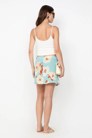 Calliope Mini Skirt by Bec and Bridge — a floral wrap mini with a beaded waist and hip cutout, perfect for polished day-to-night styling.