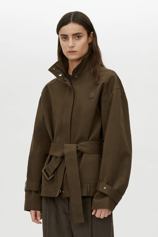 Aileron Bomber Trench in Cypress by Camilla and Marc, zip-through bomber-style trench, branded leather patch, pleated front and back, topstitched belt with pewter buckle, made from 100% cotton and 100% recycled polyester lining.