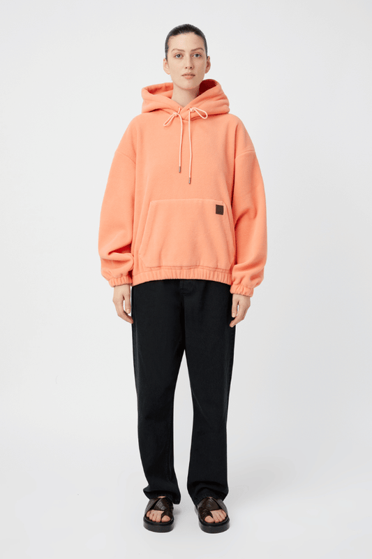 Gemma Polar Fleece Hoodie Flamingo by Camilla and Marc, cozy fleece with luxe leather patch and elastic trims for elevated streetwear appeal.