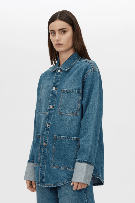 Sadie Denim Jacket in Classic Blue by Camilla and Marc, oversized fit with distressed details, wide turn-up cuffs, embossed logo buttons, patch pockets, and made from 100% cotton.