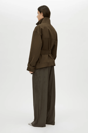 Tait Lounge Pant in Elm by Camilla and Marc, relaxed pant with deep pleats, slanted front pockets, back welt pockets, jigger button and hook-and-bar closure, crafted from 94% polyester and 6% elastane.