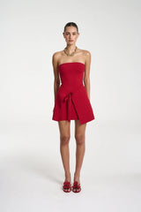 Candy Mini Dress by Summi Summi — a cardinal red strapless knit mini with tie-front detail and flared silhouette, perfect for confident styling.