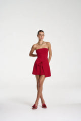 Candy Mini Dress by Summi Summi — a cardinal red strapless knit mini with tie-front detail and flared silhouette, perfect for confident styling.