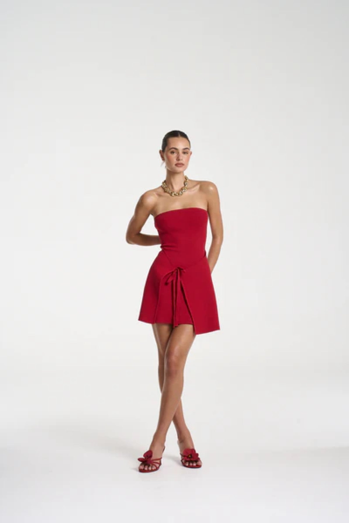 Candy Mini Dress by Summi Summi — a cardinal red strapless knit mini with tie-front detail and flared silhouette, perfect for confident styling.