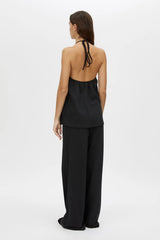 Canova Apron Top by Camilla and Marc, a black jersey apron-style tank with tie-back straps, side splits and embroidered hem.