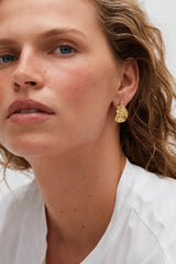 Capri Earrings Gold by Heaven Mayhem – sculptural gold swirl earrings in polished stainless steel.