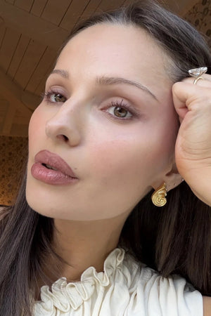 Capri Earrings Gold by Heaven Mayhem – sculptural gold swirl earrings in polished stainless steel.