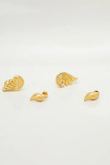 Capri Earrings Gold by Heaven Mayhem – sculptural gold swirl earrings in polished stainless steel.