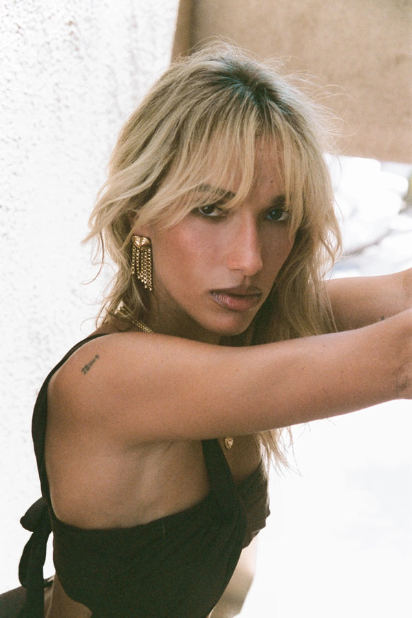 Carmen Earrings by Porter Jewellery — gold heart-drop earrings with chain fringe and a polished textured finish, perfect for bold feminine styling.