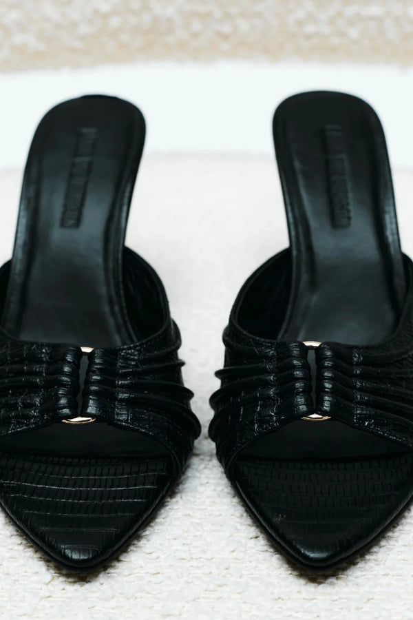 Carrie Mule by Lana Wilkinson, black lizard-embossed leather with gathered straps and stiletto heel. Perfect for chic day-to-night wear.