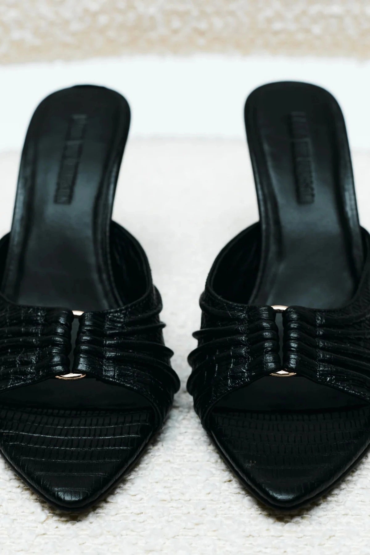 Carrie Mule by Lana Wilkinson, black lizard-embossed leather with gathered straps and stiletto heel. Perfect for chic day-to-night wear.