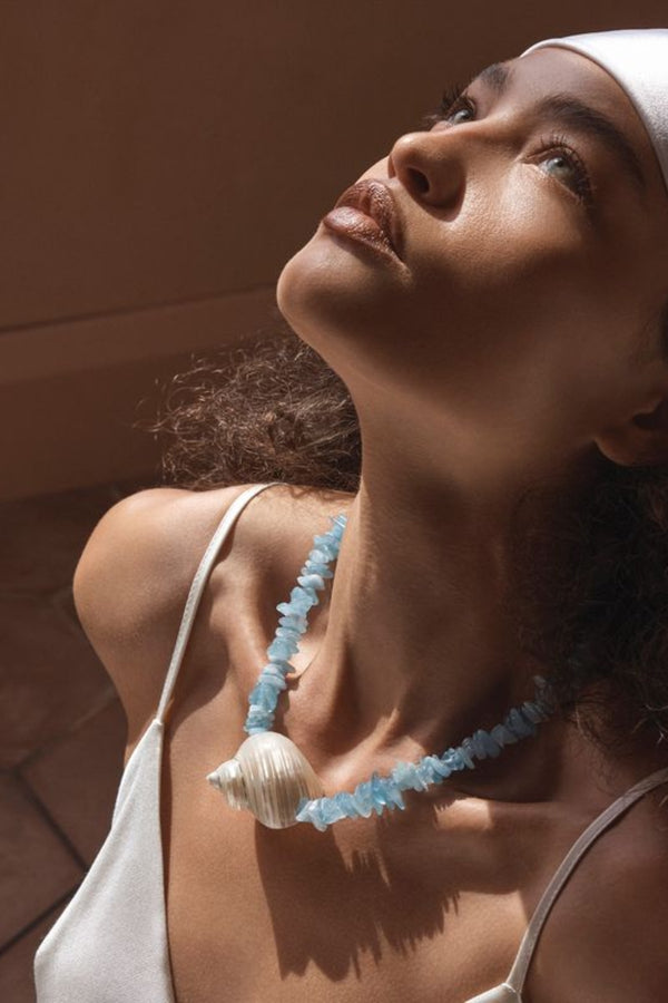Cassis Necklace by Amber Sceats, handcrafted in Italy with aquamarine stones and seashells plated in 24K gold for coastal luxury.
