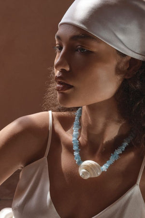 Cassis Necklace by Amber Sceats, handcrafted in Italy with aquamarine stones and seashells plated in 24K gold for coastal luxury.