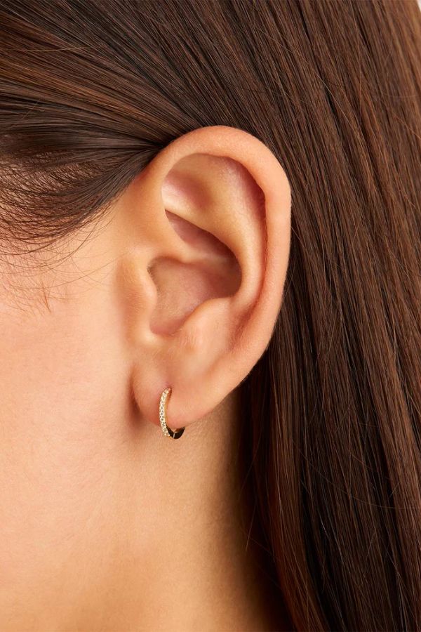 14k Solid Gold Celestial Sleeper by By Charlotte, delicate hoop earring encrusted with white cubic zirconia crystals, perfect for effortless stacking or celestial-inspired layers. Sold as a single earring.