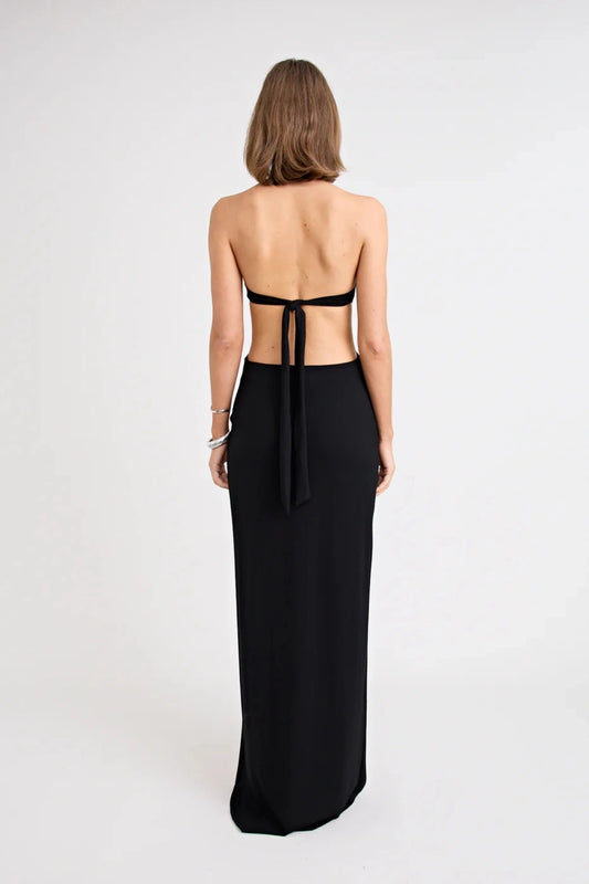 Charlie Dress Black by Pfeiffer, featuring a halter neckline, waist cut-outs and a tulip hem for an effortlessly flattering evening look.
