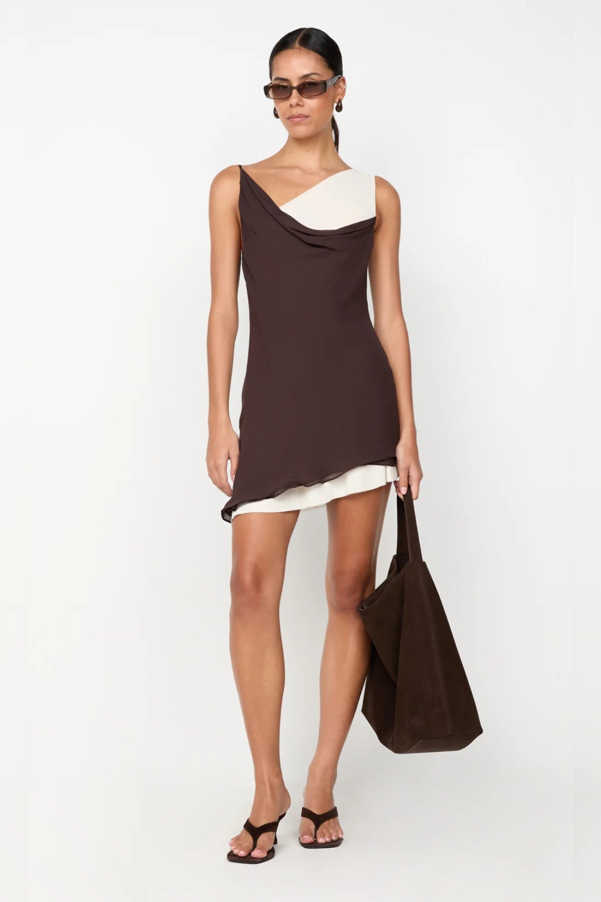 ChatGPT said:

Jehnaya Asym Mini Dress by Bec + Bridge, an asymmetric dual-tone mini with cowl neckline, knotted shoulder, and mesh contrast for modern allure.