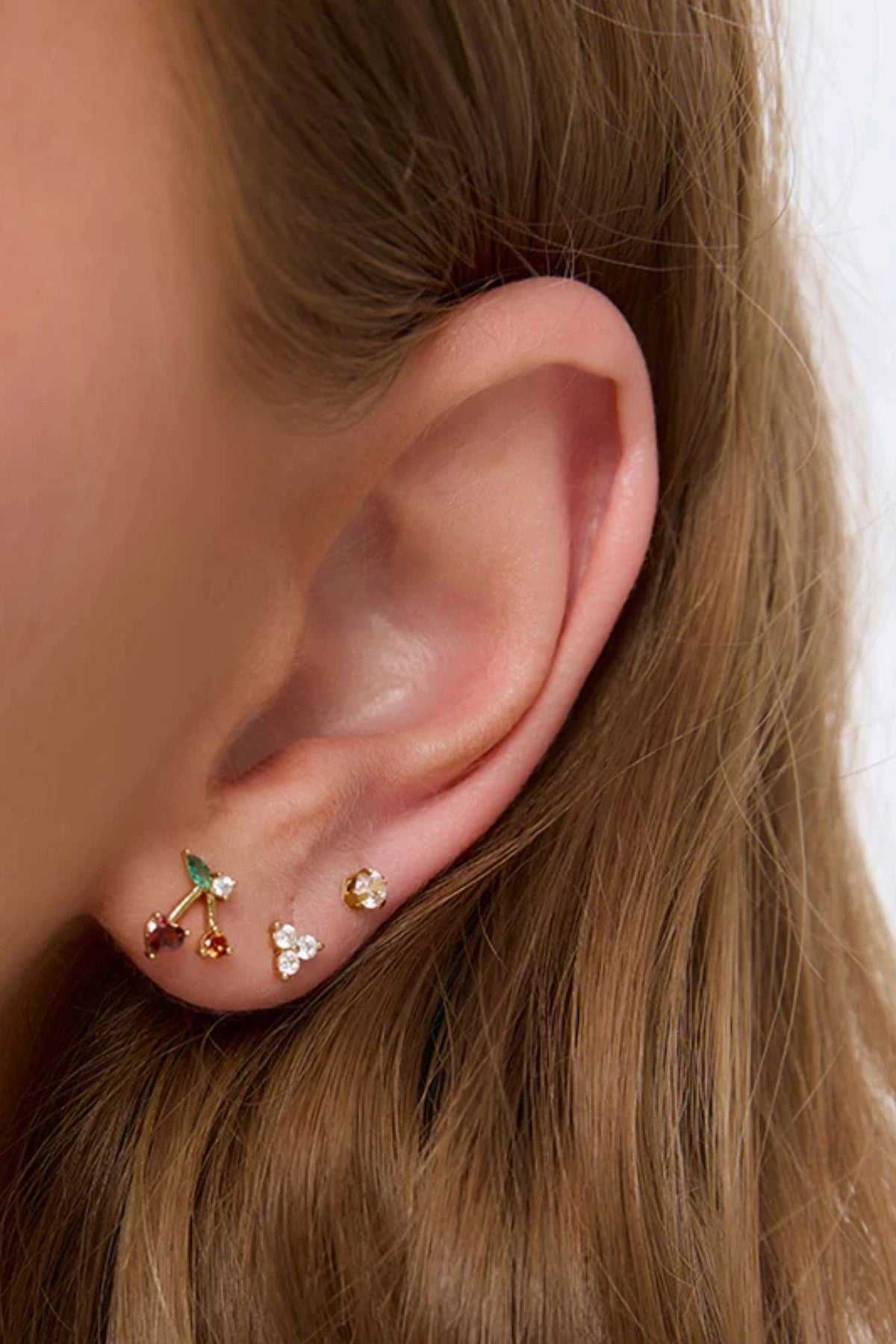 Cherry Bomb Stud Earrings by Arms of Eve, playful cherry-inspired studs with vibrant zircon stones for a fun, colourful pop to any ear stack.