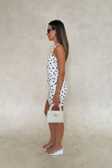 Chrissy Mini Dress White Polka Dot by Sneaky Link – a fitted cotton mini with ruching and tie straps. Perfect for feminine styling.