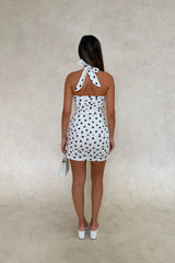 Chrissy Mini Dress White Polka Dot by Sneaky Link – a fitted cotton mini with ruching and tie straps. Perfect for feminine styling.