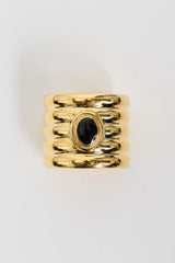 Clarke Cuff by Heaven Mayhem – a gold sculptural cuff with ridged detailing and a black enamel center, perfect for bold refined styling.