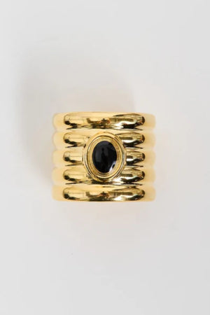 Clarke Cuff by Heaven Mayhem – a gold sculptural cuff with ridged detailing and a black enamel center, perfect for bold refined styling.