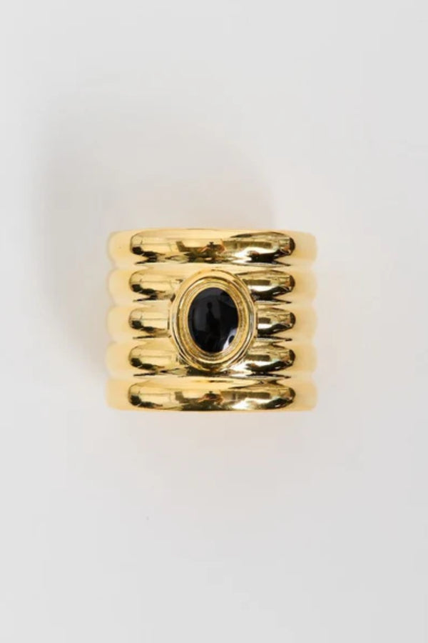 Clarke Cuff by Heaven Mayhem – a gold sculptural cuff with ridged detailing and a black enamel center, perfect for bold refined styling.