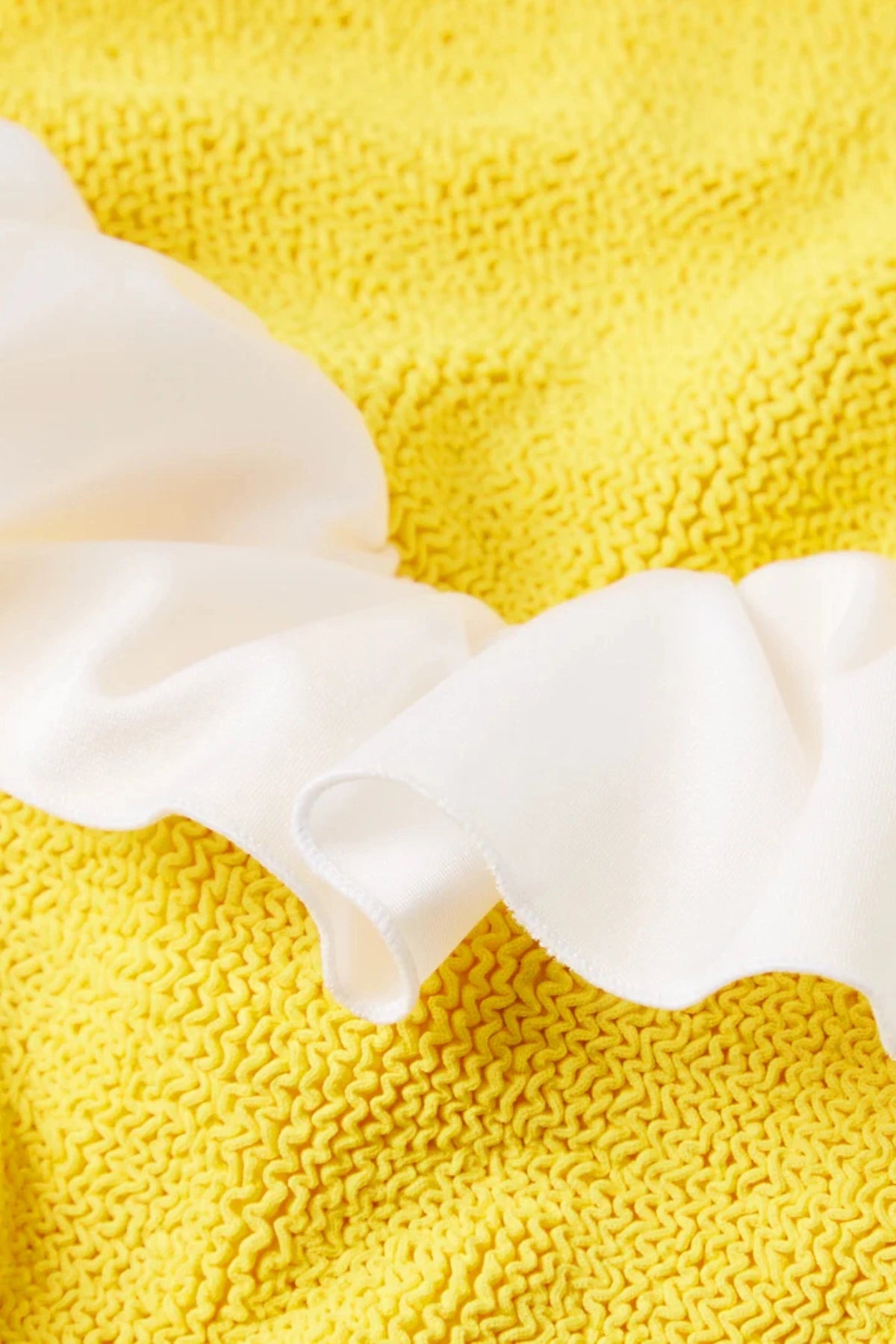 Classic Swim Sunflower by Hunza G, a stretchy crinkle one-piece for ages 3–6. Perfect for beach play, dancing, or dress-up fun.