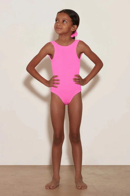 Classic Swim in Bubblegum by Hunza G, a soft crinkle one-piece for ages 3–6. Perfect for twirls, beach days, and playful adventures.