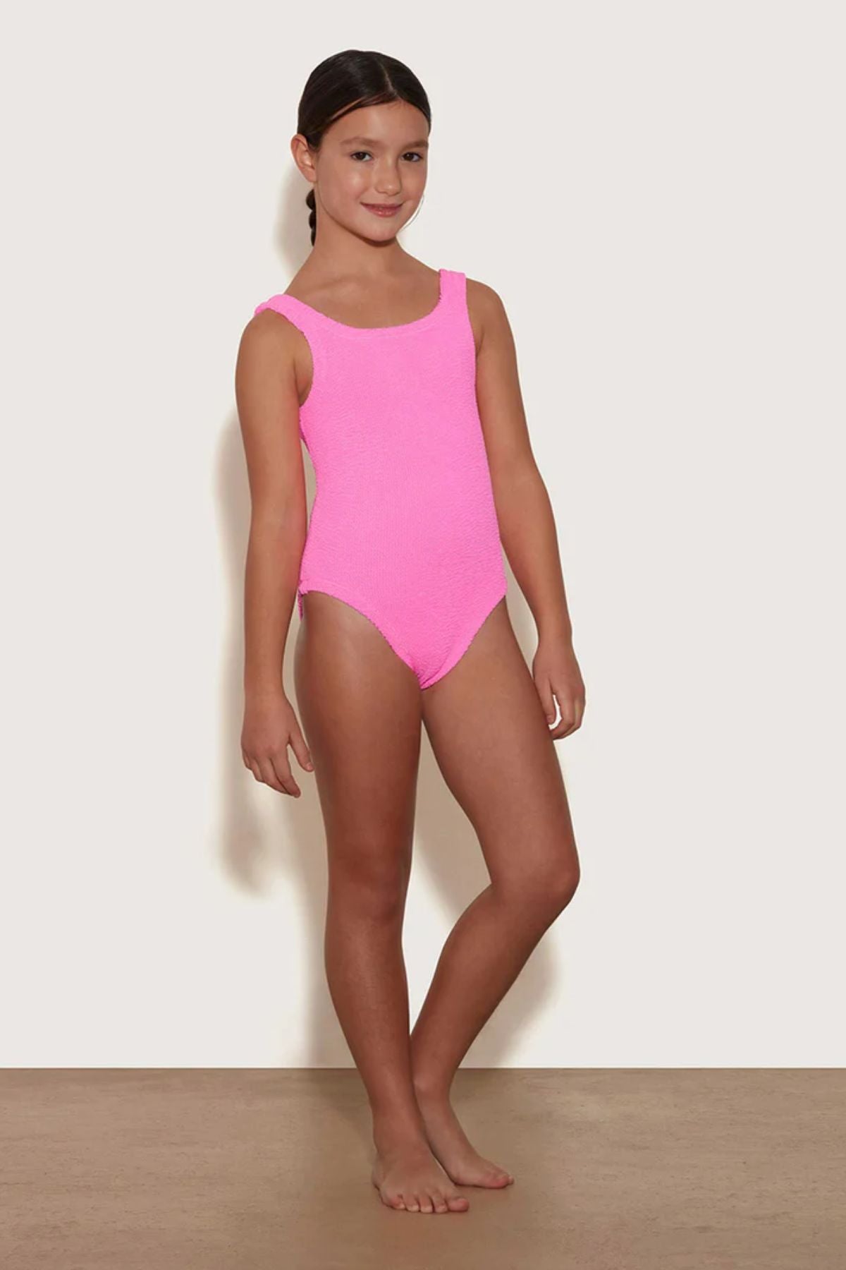 Classic Swim in Bubblegum by Hunza G, kids’ crinkle one-piece with a square neckline for ages 7–12. Perfect for sunny pool and beach days.