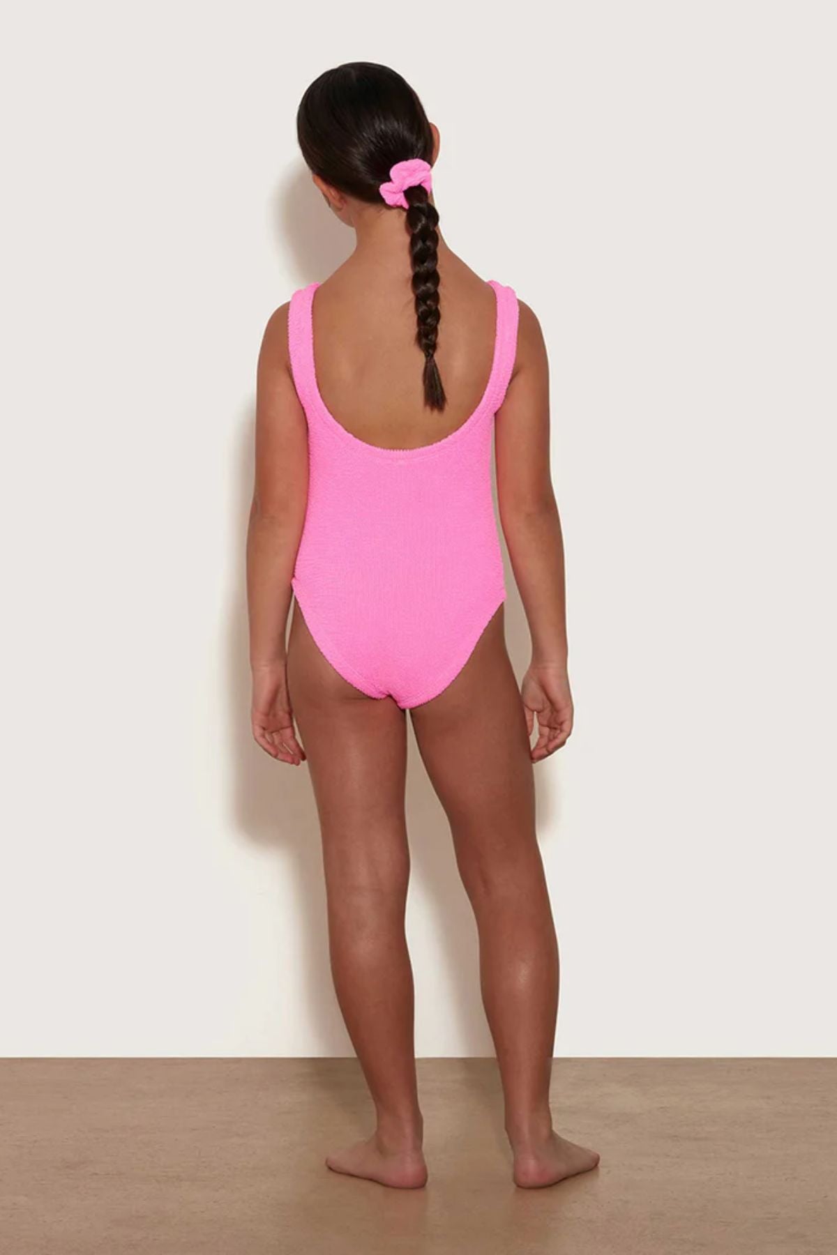 Classic Swim in Bubblegum by Hunza G, kids’ crinkle one-piece with a square neckline for ages 7–12. Perfect for sunny pool and beach days.