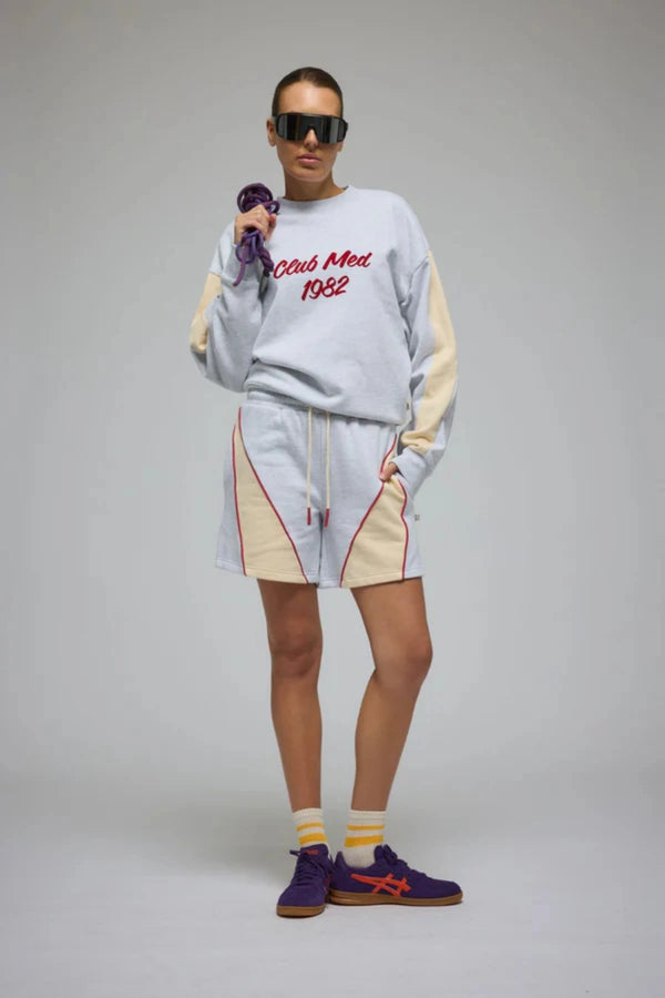 Club Med Sweatshirt in Cloud by Araminta James, relaxed cotton brushed fleece with contrast sleeves and velvet applique, perfect for chic everyday sets.