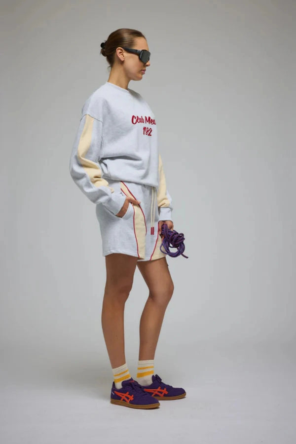 Club Med Sweatshirt in Cloud by Araminta James, relaxed cotton brushed fleece with contrast sleeves and velvet applique, perfect for chic everyday sets.