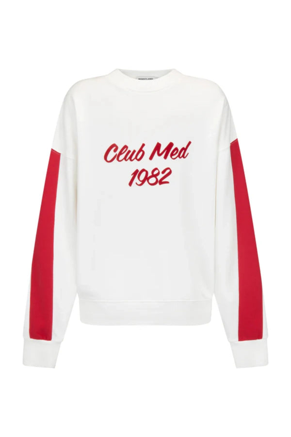 Club Med Sweatshirt in Warm White by Araminta James, soft cotton fleece with red sleeve panels and velvet chest applique, relaxed fit for chic off-duty or travel styling.