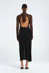 Colton Midi Dress Black by Benni – A trendy high-neck lace dress with open back, built-in bralette, and soft jersey skirt with thigh-high split, perfect for elegant evening occasions.
