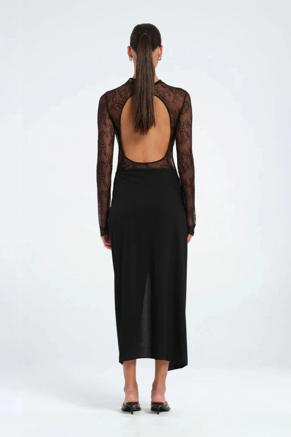 Colton Midi Dress Black by Benni – A trendy high-neck lace dress with open back, built-in bralette, and soft jersey skirt with thigh-high split, perfect for elegant evening occasions.