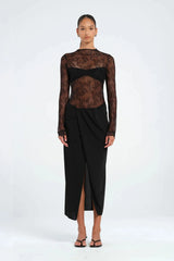 Colton Midi Dress Black by Benni – A trendy high-neck lace dress with open back, built-in bralette, and soft jersey skirt with thigh-high split, perfect for elegant evening occasions.